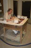  Here we see him as he uses a mold form on the potters wheel to get the proper shape.